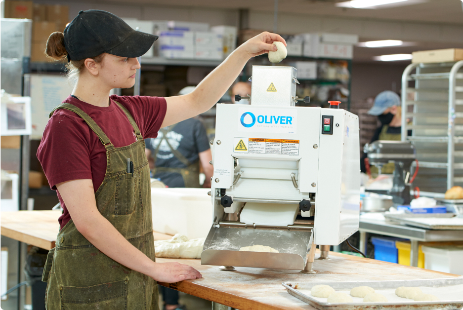 Dough equipment in use at a bakery.